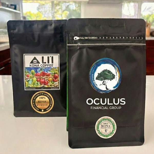 coffee bags with Ali'i Kona Coffee and Oculus Financial Group logos on a white surface.