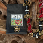 Ali'i Kona Coffee bag with decorative elements on a wooden background